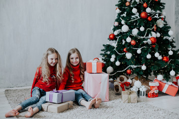 two blonde girlfriends sisters girls Christmas presents new year tree