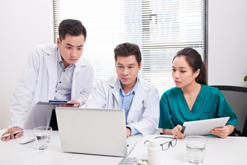 Doctor team working at computer desk in hospital