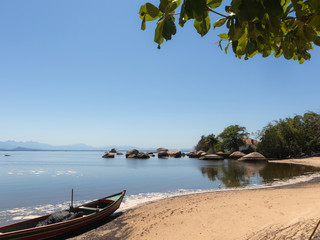 Corner of Catimbaú Beach, with fishing boat and rocks in the background, Paqueta, Rio de Janeiro, Brazil