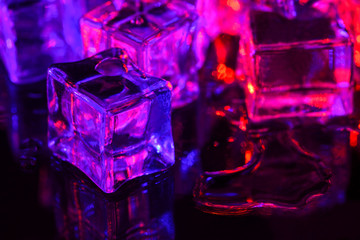 Ice cube. Melting ice cubes with pink purple backlight. Macro horizontal photography.