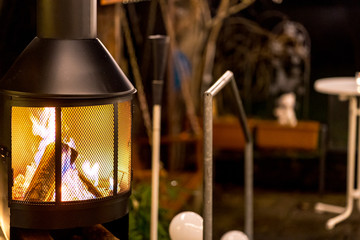 outdoor wood stove with burning open fire (nighttime)