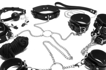 BDSM set, leather collar with clips on the nipples, gag and leather Handcuffed on the hands.