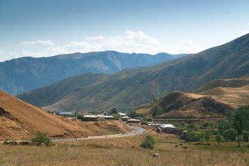 House and yurts on road trip from Osh Kyrgyzstan to Tajikistan through the Pamir highway