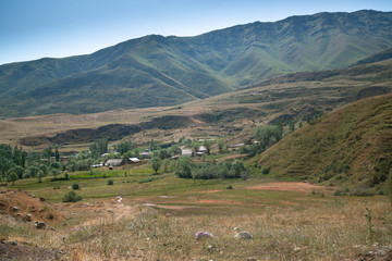 House and yurts on road trip from Osh Kyrgyzstan to Tajikistan through the Pamir highway