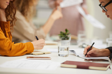 Unrecognizable women practicing brainstorming during business meeting, horizontal shot
