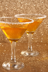 Two glasses with a yellow cocktail