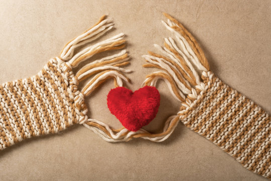 Furphy red heart. Symbol of Love and Valentine's Day. Scarf like two human hands. Granite stone background. Valentine's Day concept photo.