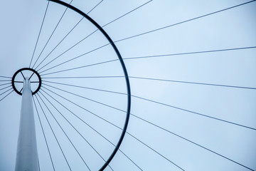 Bottom view of abstract tower background against clouded sky