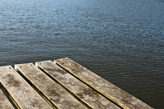 A wooden getty next to a tranquil river. Mindfulness and meditation background image. 