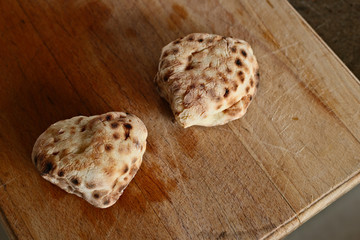 Traditional South African roosterbrood on a wooden board. This is a popular food snack in South Africa. 