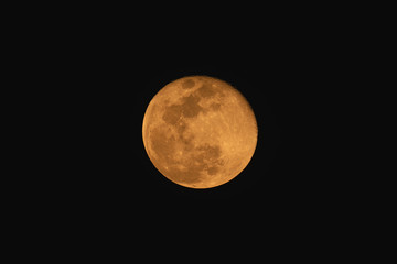 Full moon over dark black sky at night with telephoto lens isolated on transparent background.