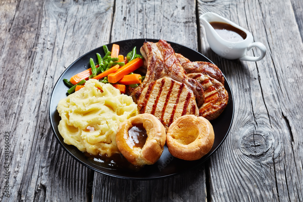 Wall mural English Sunday roast on a black plate