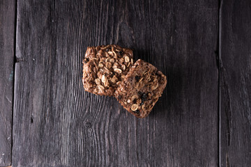 oatmeal and chocolate muffins lie on a wooden gray table in rustic style. healthy food prescription