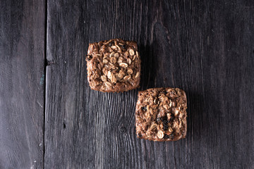 oatmeal and chocolate muffins lie on a wooden gray table in rustic style. healthy food prescription