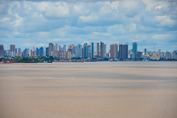 Naklejka premium View of City Belem from the Para river. Many skyscrapers and brown color water.
