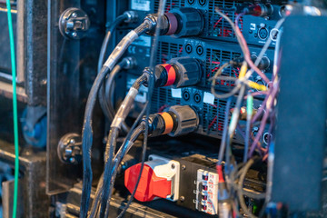 Closeup of the plugged in industrial cables on the concert backstage 