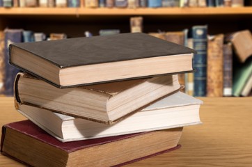 Old vintage books stacked on desk