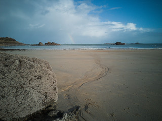 beach at sunset with rainbow
