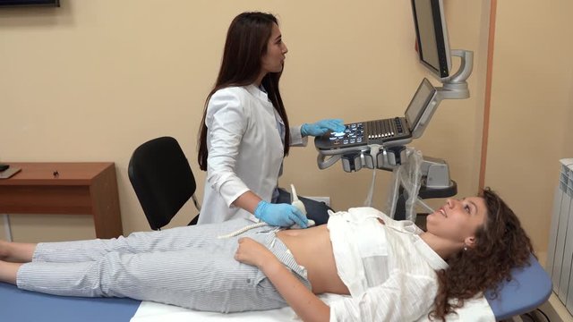 In the Hospital, Doctor Doing Ultrasound / Sonogram Scan to a Pregnant Woman.