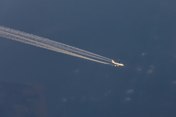 Trail from the airplane with four enigine, aerial view.