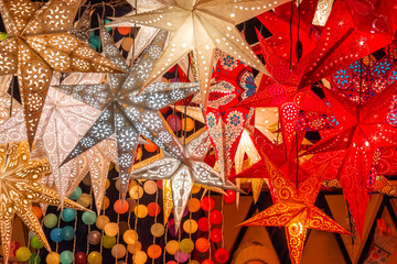 Paper bright multi-colored Christmas and New Year stars decorations.