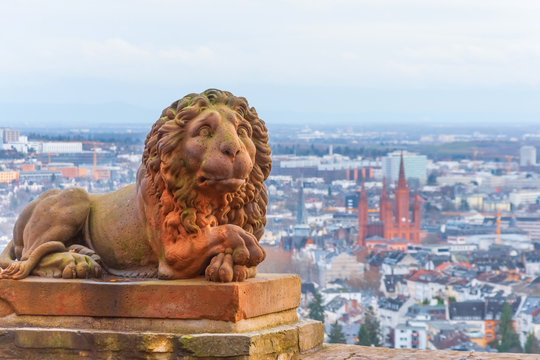 Wiesbaden in Hessen Germany view from Neroberg, in the foreground a statue of a lion, in the background a view of the city.