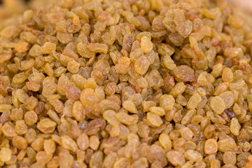 Raisins, made from yellow and green dry grapes, close-up,