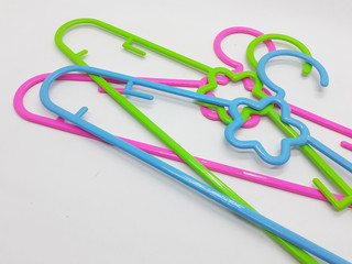 Various Bright Colorful Plastic Hanger for Clothes Drying Room Appliances in White Isolated Background 