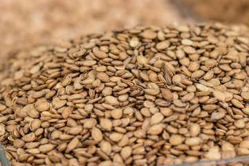 Roasted and salted watermelon seeds in a beautiful pile, isolated by a blurred background, the Jerusalem market.