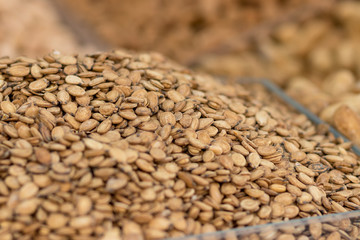 Roasted and salted watermelon seeds in a beautiful pile, isolated by a blurred background, the Jerusalem market.