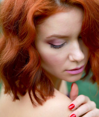 Fototapeta premium beautiful red-haired girl in arranger where azalea blooms in a colorful flying dress