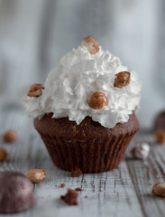 Delicious chocolate brownie muffins with nuts and whipped cream