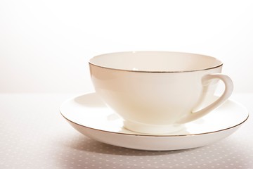 white tea cup and saucer