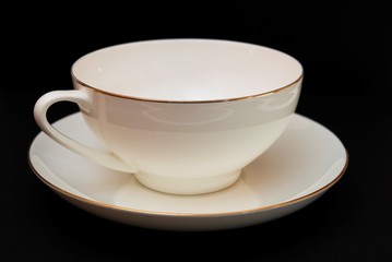 white tea cup and saucer