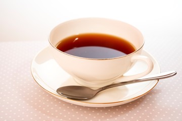 tea in a white cup on a saucer