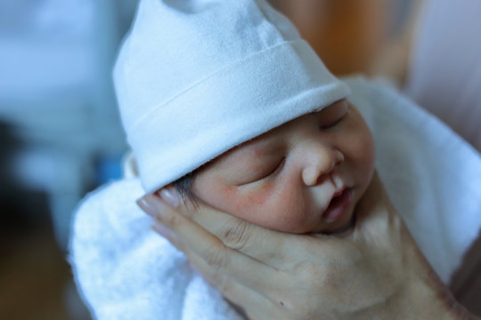 mother parenting, mom using hand help a baby newborn belch burping after breastfeeding milk