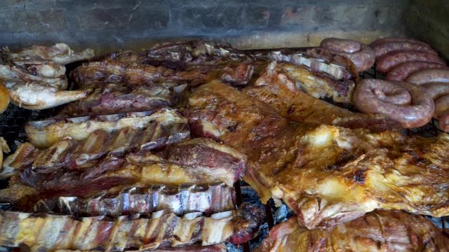Tasty Argentinian barbecue called asado being grilled in traditional parrilla