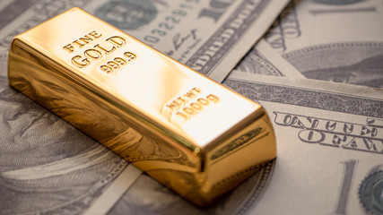 gold bar overlay  money dollars, Concept   In a poor economy Investors should hold dollar or gold.