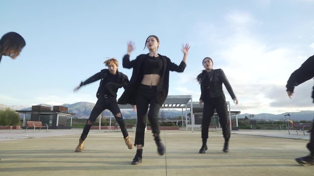 Young STREET PERFORMER performing on the street. Seven chinese teenagers dancing kpop