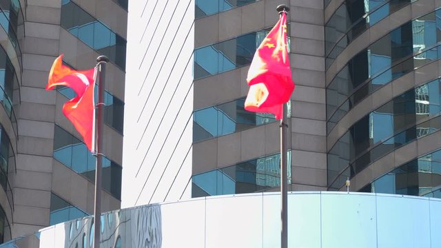 Hong Kong Flag and China Flag Waving On A Skyscraper Building In Hong Kong