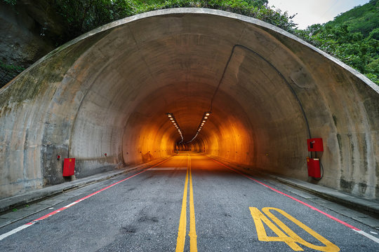 Fototapeta Entrance into the long tunnel in the mountains