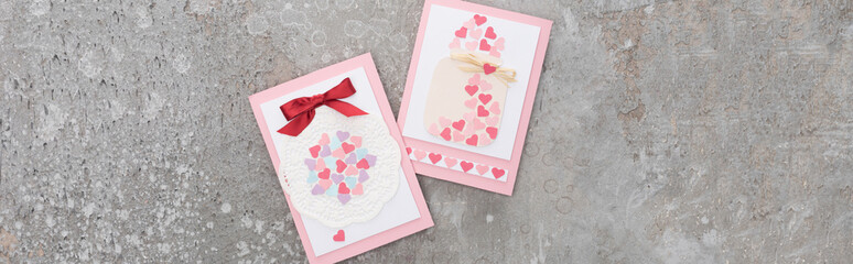 top view of valentines greeting cards on concrete grey background, panoramic shot