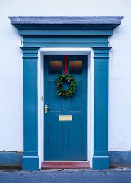 Christmas holiday wreath on beautiful entrance door