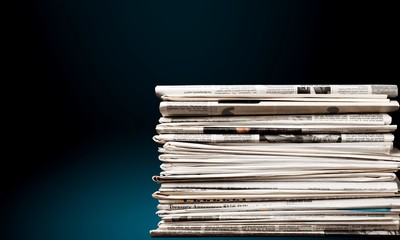 Pile of newspapers on white background