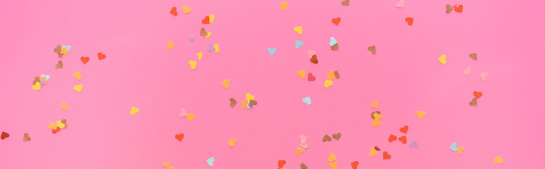 top view of valentines confetti scattered on pink background, panoramic shot