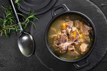 Chicken gizzards stewed with carrot in sauce.