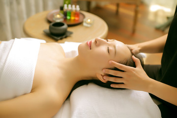 Asian women are enjoying head and face massage at spa