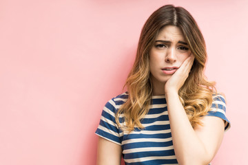 Unhappy Female Feeling Dental Pain Against Isolated Background