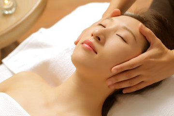 Massaging asian woman's face