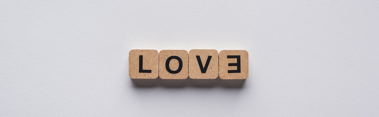 top view of cubes with love lettering on white background, panoramic shot
